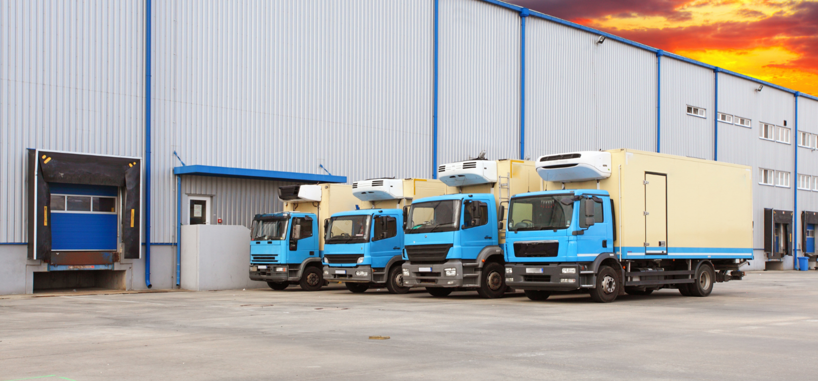 LKW's stehen vor den Laderampen einer Lagerhalle