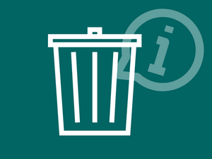 Eine weiße Mülltonne vor einem dunkelgrünen Hintergrund 